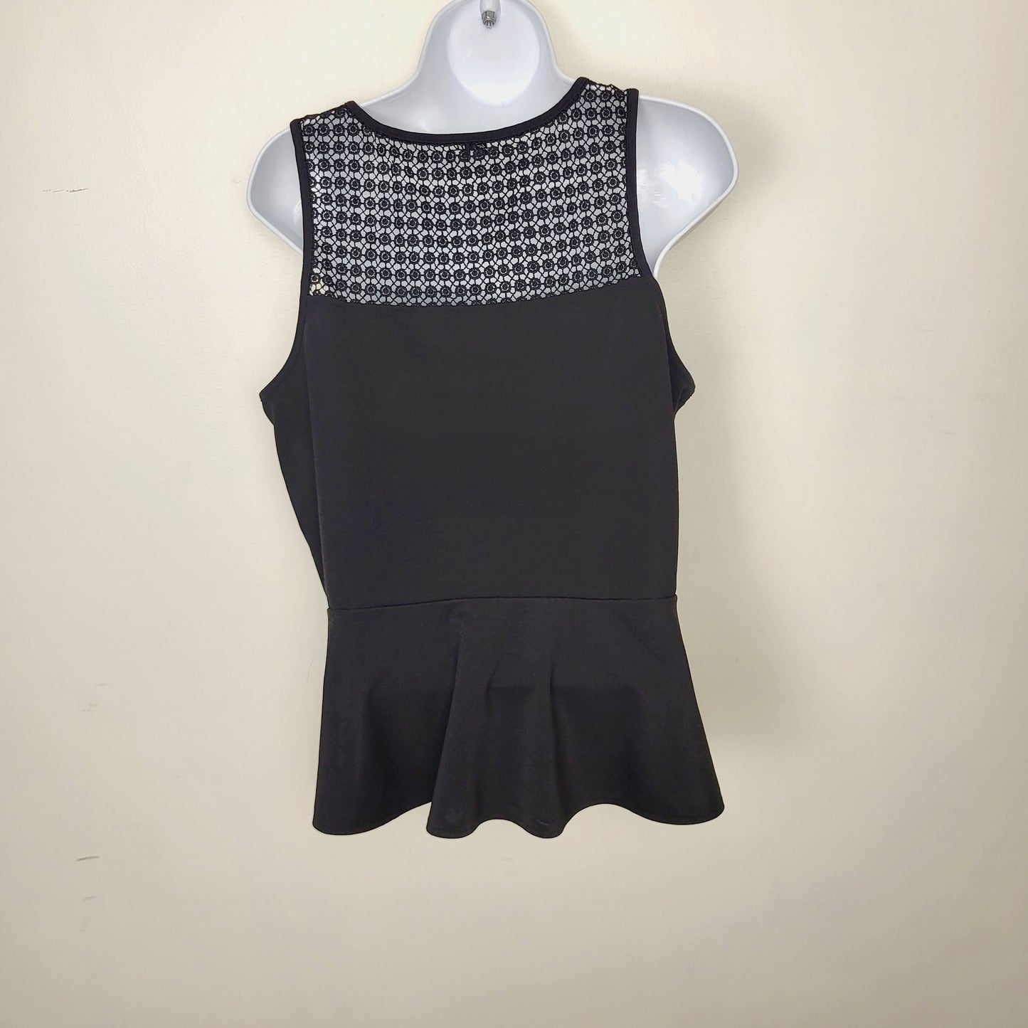 AMRO1 - Kismet black sleeveless peplum top with flower detail. Size large (closer to a medium)