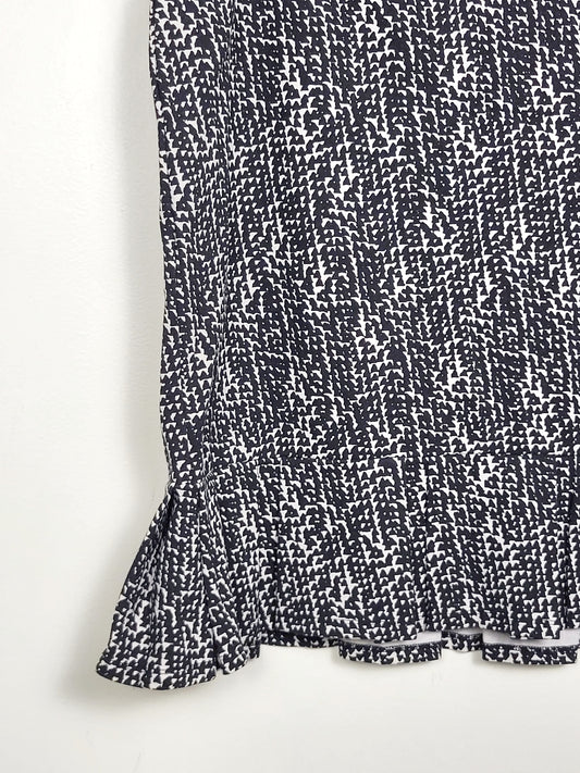 Ann Taylor black and white pencil skirt with ruffle hem. Size 12