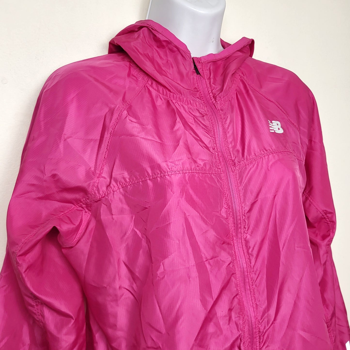 BBIN1 - New Balance pink hooded windbreaker with reflective strips. Size medium