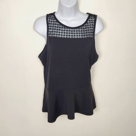 AMRO1 - Kismet black sleeveless peplum top with flower detail. Size large (closer to a medium)